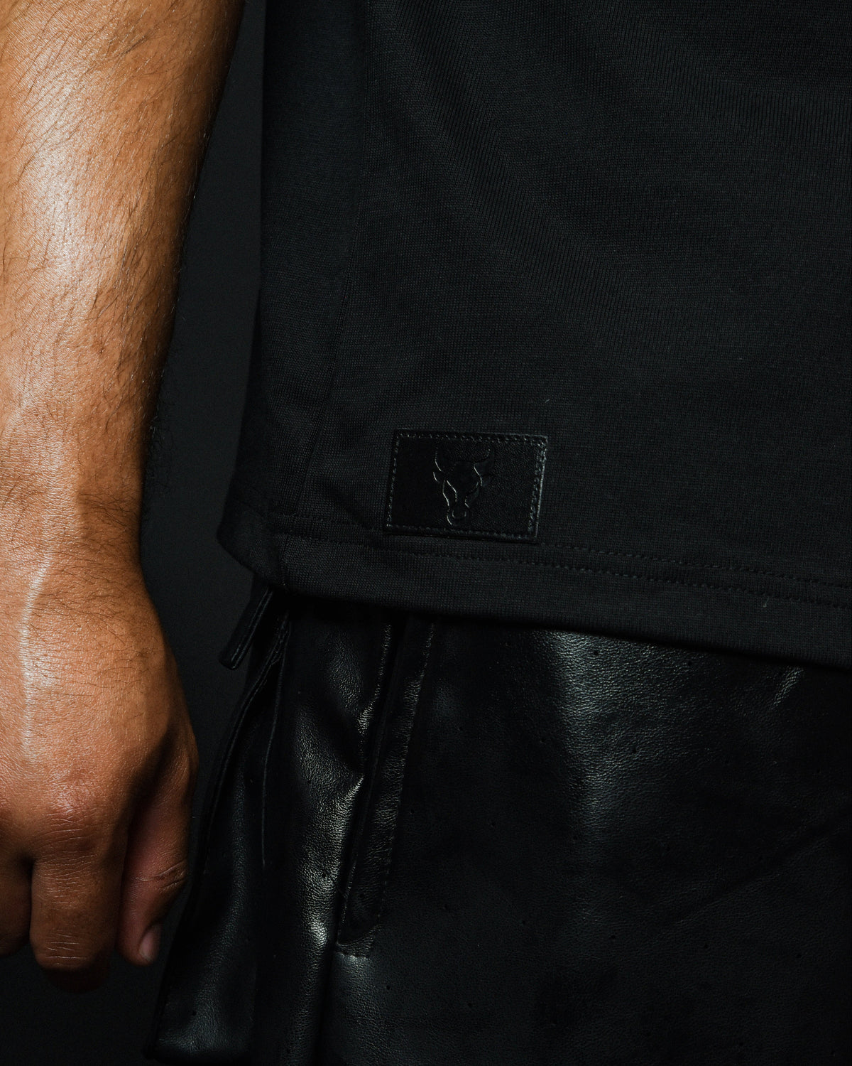 Close-up of leather logo tag on MALDITO The Break tee
