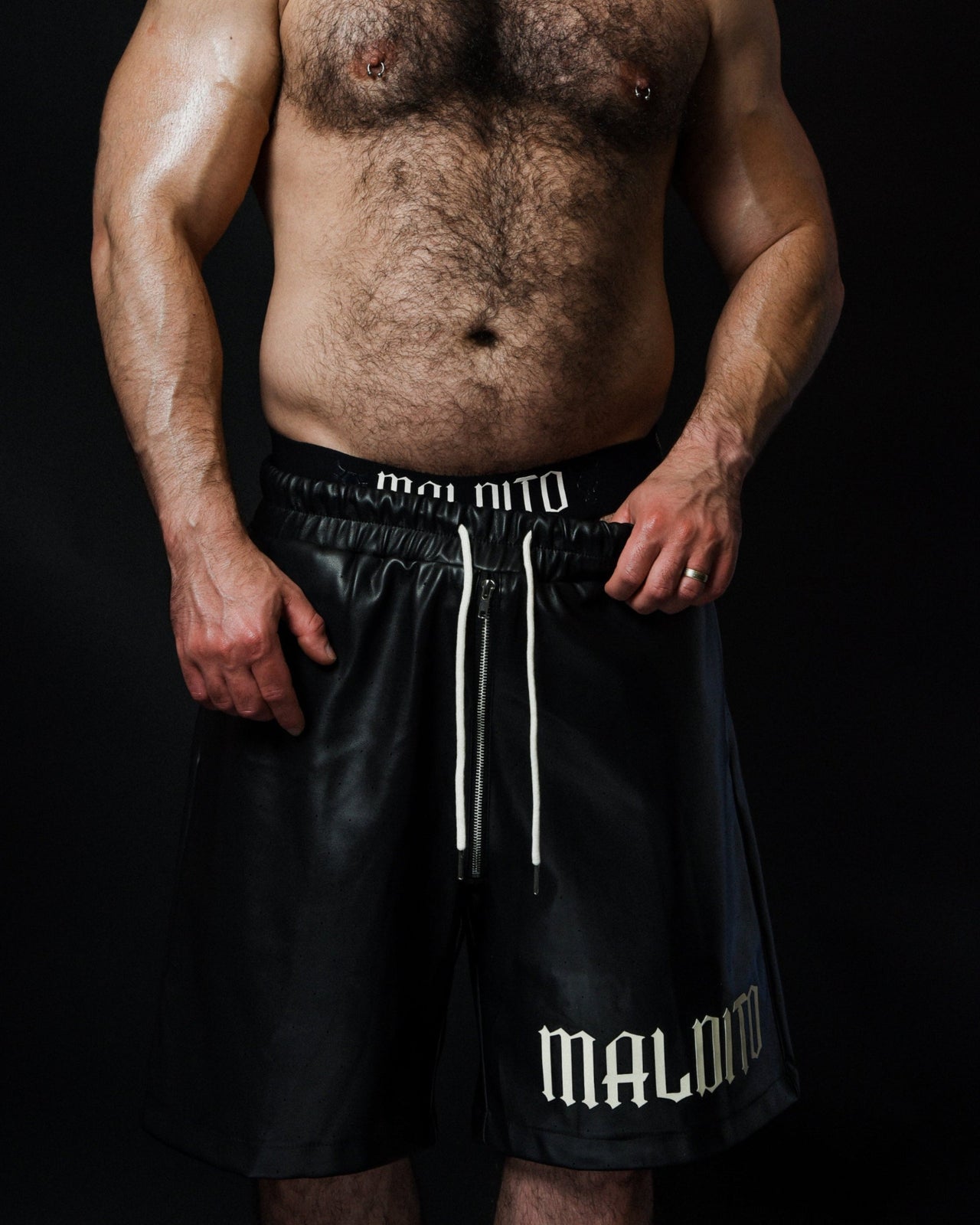 Front view of model pulling side of MALDITO Restraint leather shorts