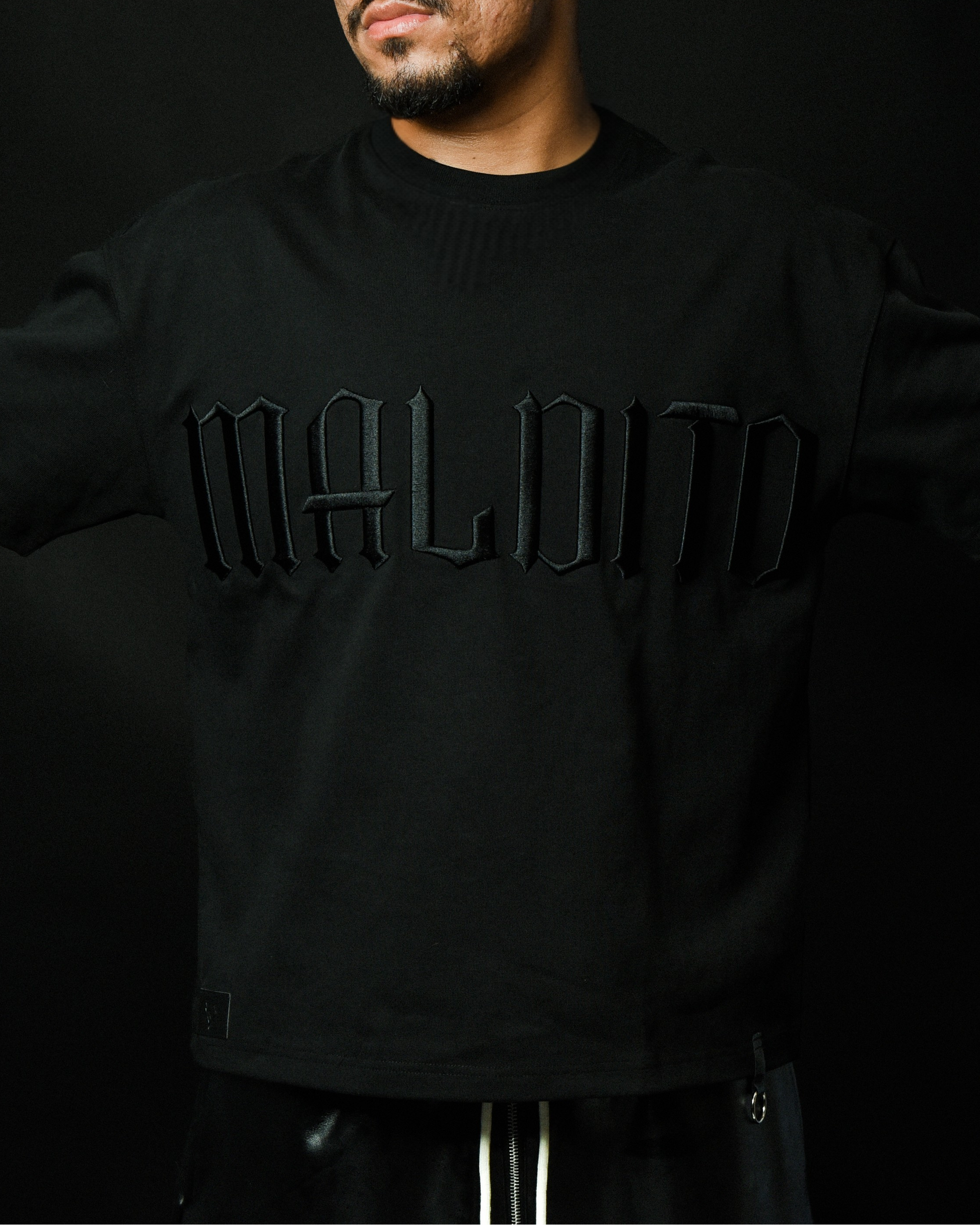 Front view of model wearing MALDITO The Break tee with arms raised