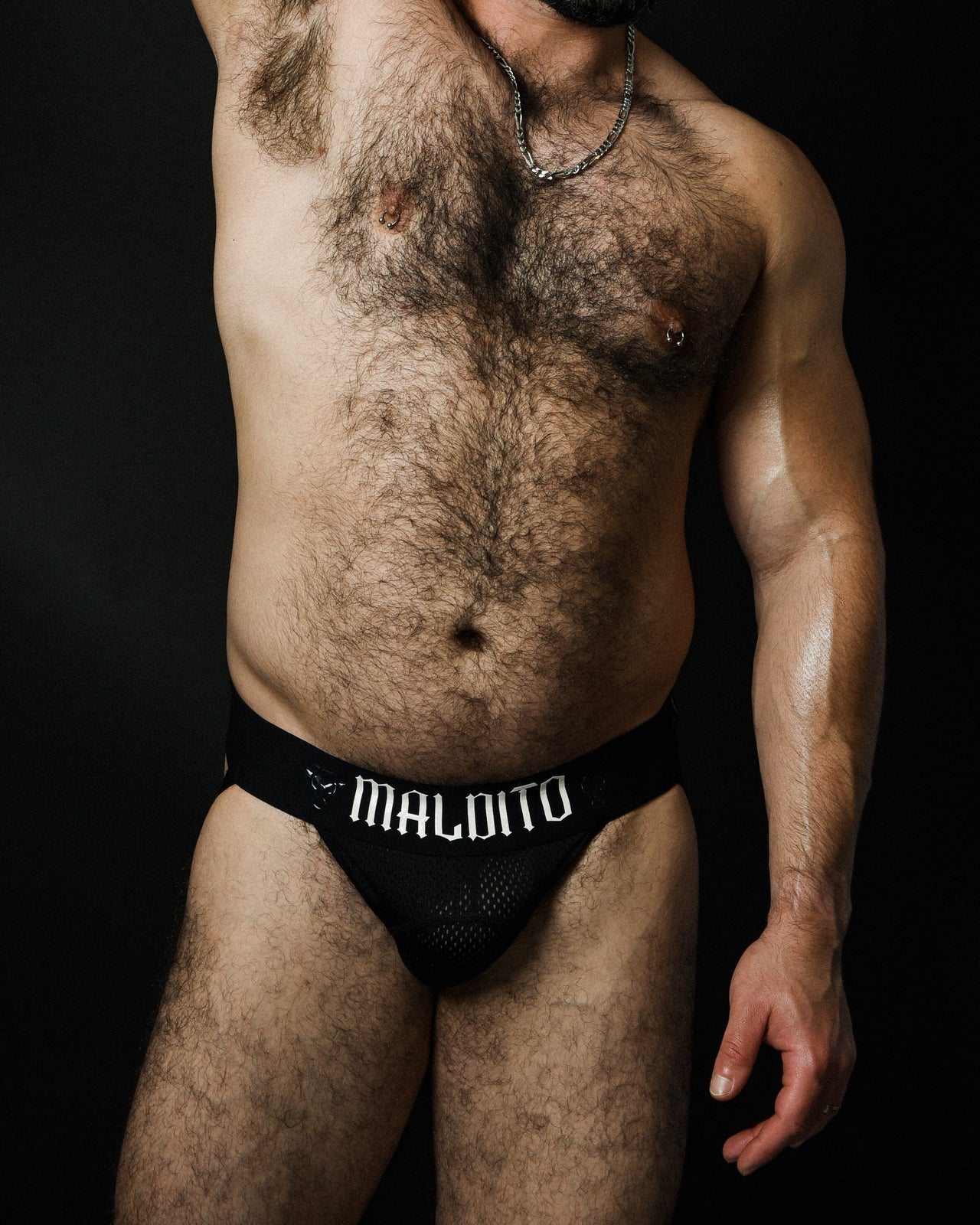 Front view of model wearing MALDITO The Core jockstrap with arm raised