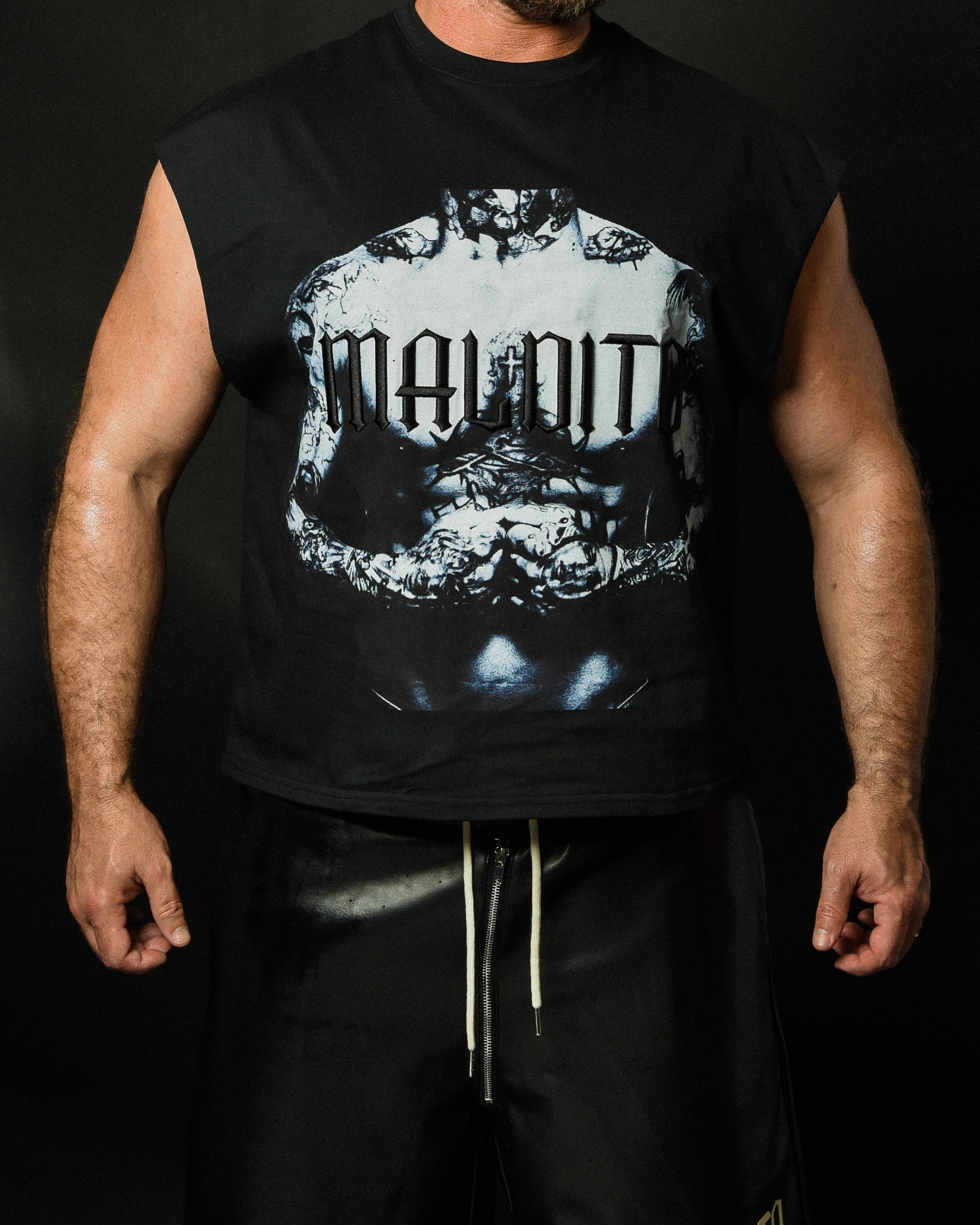 Angled front view of model wearing MALDITO The Forged cut-off tee